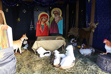 Christmas Eve: nuns and churchgoers decorate the church, Christmas trees and erect the Christmas crib