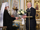 Belarus President Alexander Lukashenko lights a Christmas candle at the Holy Spirit Cathedral in Minsk 