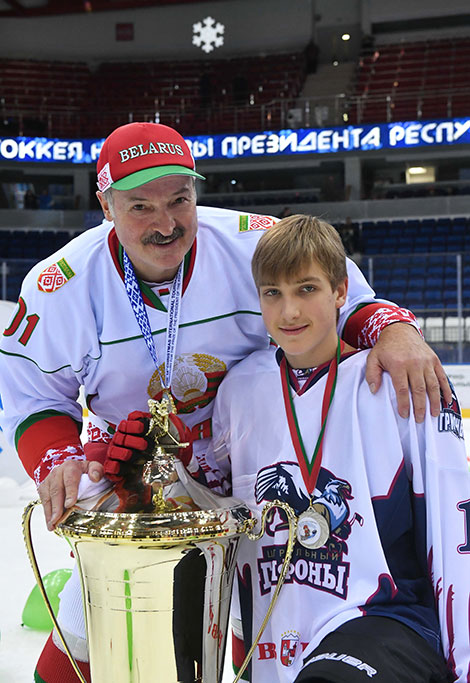 Alexander and Nikolai Lukashenko pose with the Christmas Tournament Cup