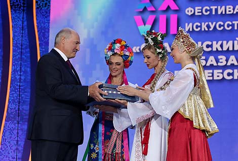 The festival organizers give Alexander Lukashenko an amulet belt