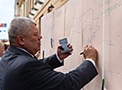 Grodno Mayor Mechislav Goi is writing a message for the city