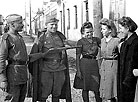 Red Army Troops Commander Nikolai Reshetnikov and his fellow soldier talk to Grodno residents on the day of the city’s liberation from the Nazis, 16 July 1944