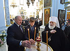 Belarus President Alexander Lukashenko lights Christmas candle in Holy Spirit Cathedral in Minsk