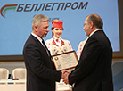 Chairman of Bellegprom Concern Nikolai Yefimchik presents an honorary certificate to Director General of OAO Lenta Sergei Petrov