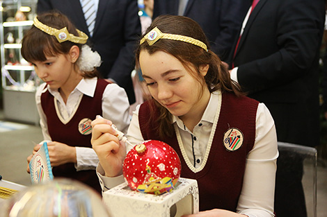 Мотивы слуцких поясов, снеговики и снежинки - в Минске расписали елочные шары для детдомов
