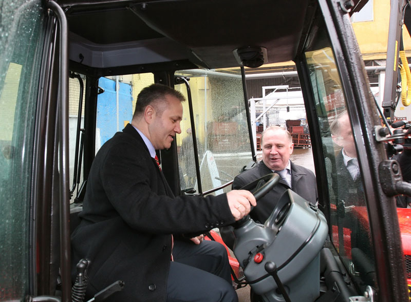 Serb minister steering a Belarusian tractor