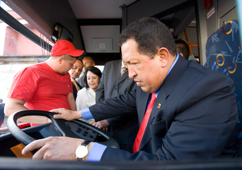 Hugo Chavez behind a MAZ bus wheel