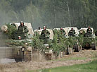 A column of self-propelled howitzers Giatsint of the Belarusian army on the march in an exercise area