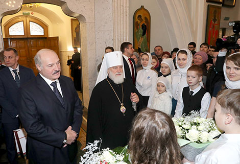 Belarus President Alexander Lukashenko lights a Christmas candle at the Holy Spirit Cathedral in Minsk 