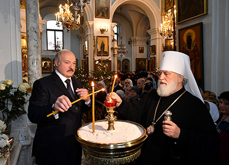 Belarus President Alexander Lukashenko lights a Christmas candle at the Holy Spirit Cathedral in Minsk 
