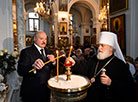 Belarus President Alexander Lukashenko lights a Christmas candle at the Holy Spirit Cathedral in Minsk 