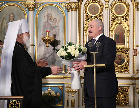 Belarus President Alexander Lukashenko lights a Christmas candle at the Holy Spirit Cathedral in Minsk 