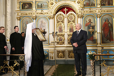 Belarus President Alexander Lukashenko lights a Christmas candle at the Holy Spirit Cathedral in Minsk 