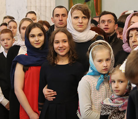 Belarus President Alexander Lukashenko lights a Christmas candle at the Holy Spirit Cathedral in Minsk 