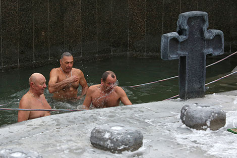 Orthodox believers take ice plunges for Epiphany near Church of All Saints in Minsk