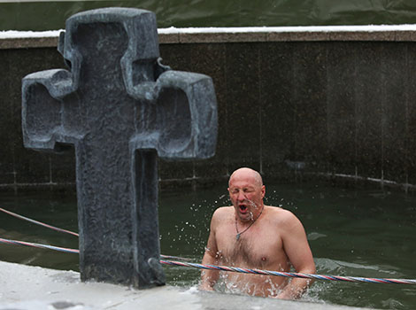 Orthodox believers take ice plunges for Epiphany near Church of All Saints in Minsk