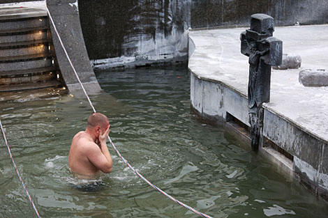 Orthodox believers take ice plunges for Epiphany near Church of All Saints in Minsk