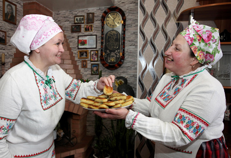 Вольга Чобат частуе таўчонікамі з бульбы з макам Веру Аўласенка