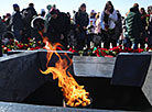 Flower ceremony at the Eternal Flame  in Khatyn Memorial