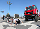 Belarus' strongman Alexander Kurak competes in MAZ truck pull