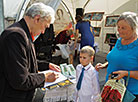 Novelist Mikhail Busko during an autograph session 