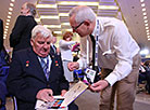 Two-time hero of the Soviet Union Pyotr Klimuk gives autographs