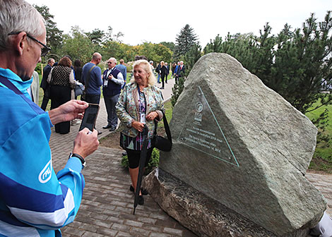 The participant of the Congress Irina Pronina behind a memorial