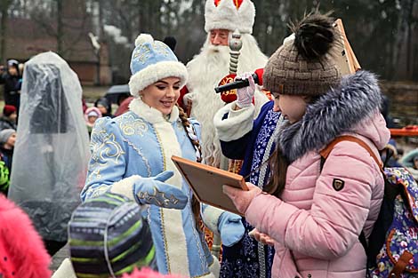 Snow Maiden presents diplomas to the winners of the children’s contest for the best snowman