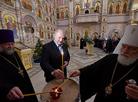 Belarus President Alexander Lukashenko lights a Christmas candle