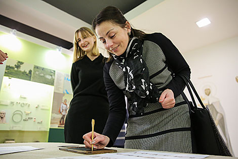 Workshop on writing ancient Cyrillic letters on a tablet with cera (wax tablet)