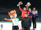 Chairman of the President’s Sport Club Dmitry Lukashenko presents awards to Women Mass Start medalists Nadezhda Skardino (Belarus), Anna Bogaliy (Russia), and Simone Hauswald (Germany)