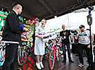 Stas Pieha presents a bike to one of the participants of Cycling Miss 2019 contest 