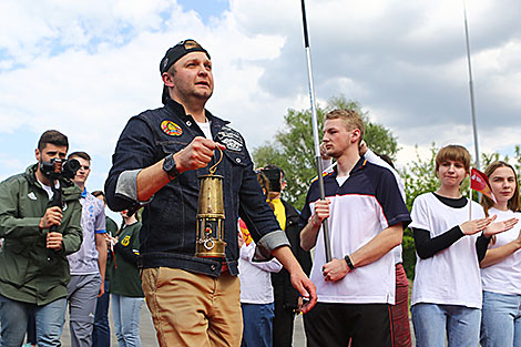 Evgeny Beizak carries a lantern with the 2nd European Games flame