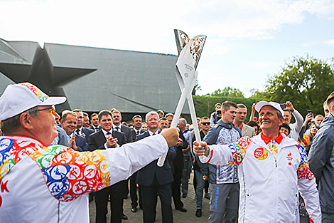 Grigory Bysyuk passes the flame to Boris Isachenko
