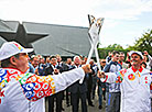 Grigory Bysyuk passes the flame to Boris Isachenko