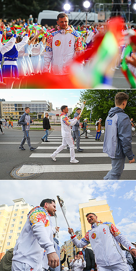 Football player Aleksandr Pavlovets passes the flame to Artyom Stavenko, one of Kino-mo project founders