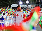 Football player Aleksandr Pavlovets passes the flame to Artyom Stavenko, one of Kino-mo project founders
