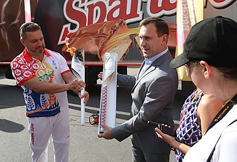 Director of Spartak confectionery Oleg Zhidkov presents a life-size chocolate copy of the torch to the guests