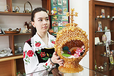 Museum guide Anastasia Bugvina demonstrates an Easter egg made of pasta