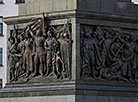 Bronze high reliefs on the facets of the pedestal depict various episodes of the war