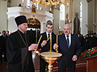 Aleksandr Lukashenko lights an Easter candle in the Holy Annunciation Church in Malye Lyady