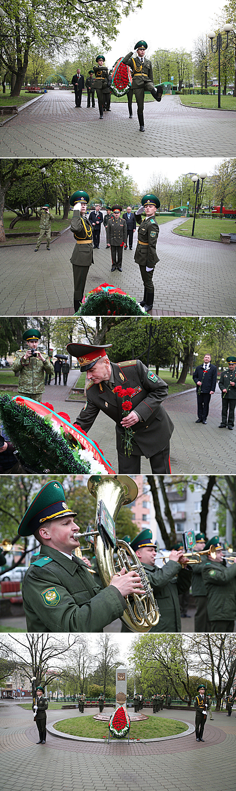 Belarusian border guards lay flowers at a monument near a mass grave in Minsk