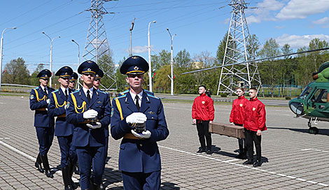 An honor guard unit escorts the capsules to the temple’s entrance