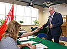 Belarus’ Education Minister Igor Karpenko takes part in early voting