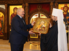 Aleksandr Lukashenko lights a Christmas candle in the Church of the Exaltation of the Holy Cross