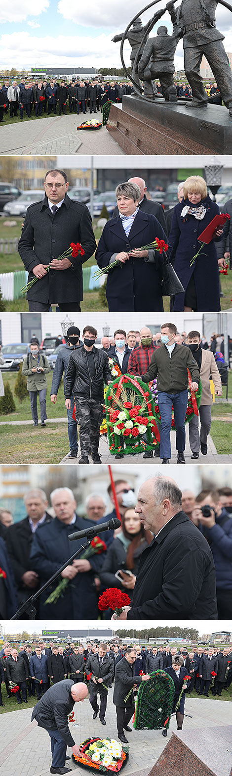 A commemorative rally near a memorial sign in honor of Chernobyl cleanup workers in Khoiniki