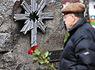 Flowers are laid at the memorial signs For Victims of Chernobyl and Hiroshima Peace Stone in Minsk