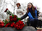 Flowers are laid at the memorial signs For Victims of Chernobyl and Hiroshima Peace Stone in Minsk