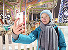 Minsk residents and visitors near the New Year Tree behind Palace of Sports in Minsk
