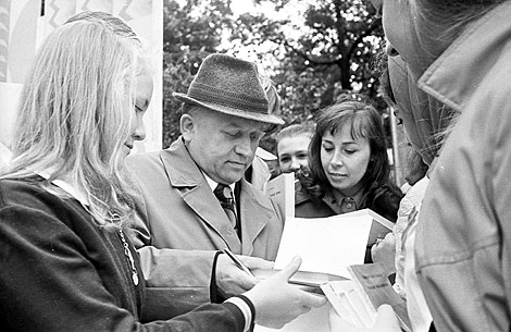 Writer Ivan Shamyakin gives autographs at an evening of poetry